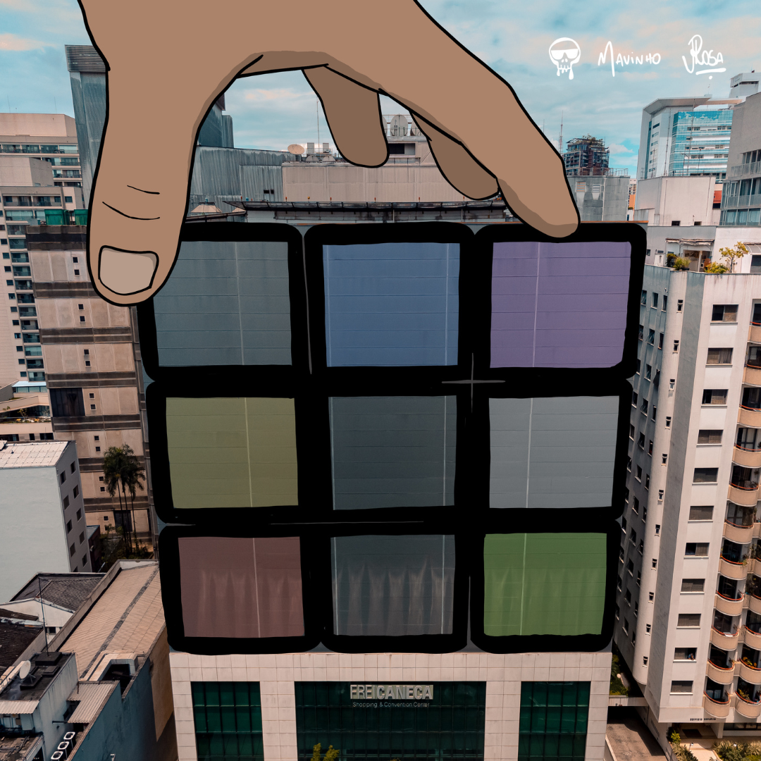 Cubo mágico é desenhado no edifício do Frei Caneca. Uma mão na parte de cima segura o cubo. 